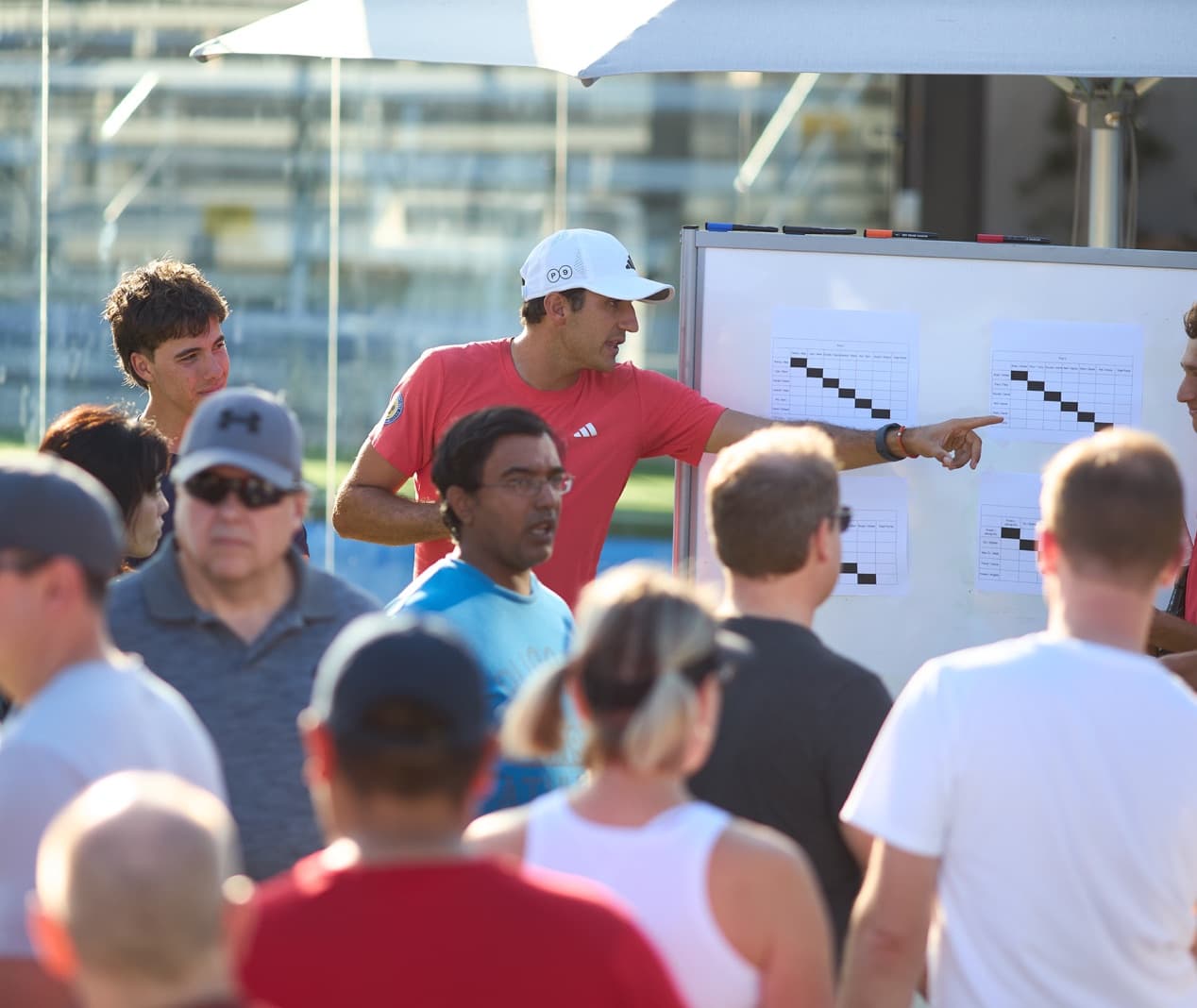 Coach reviewing an event schedule with guests