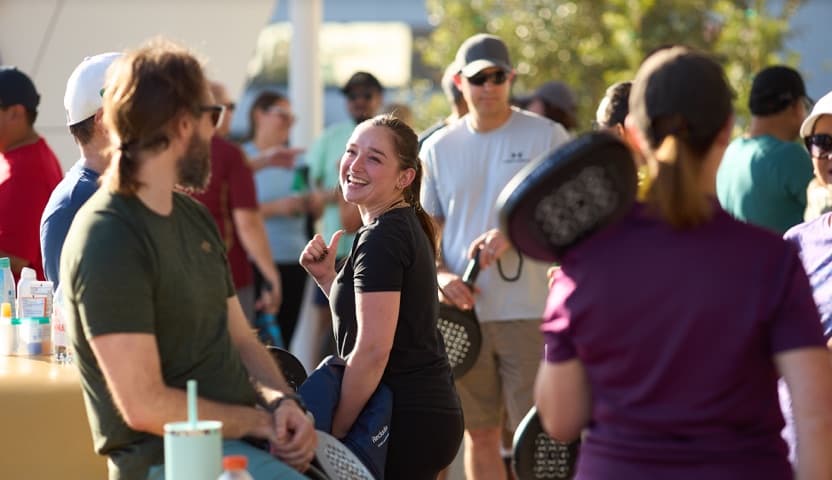 Guests socializing at a padel club event